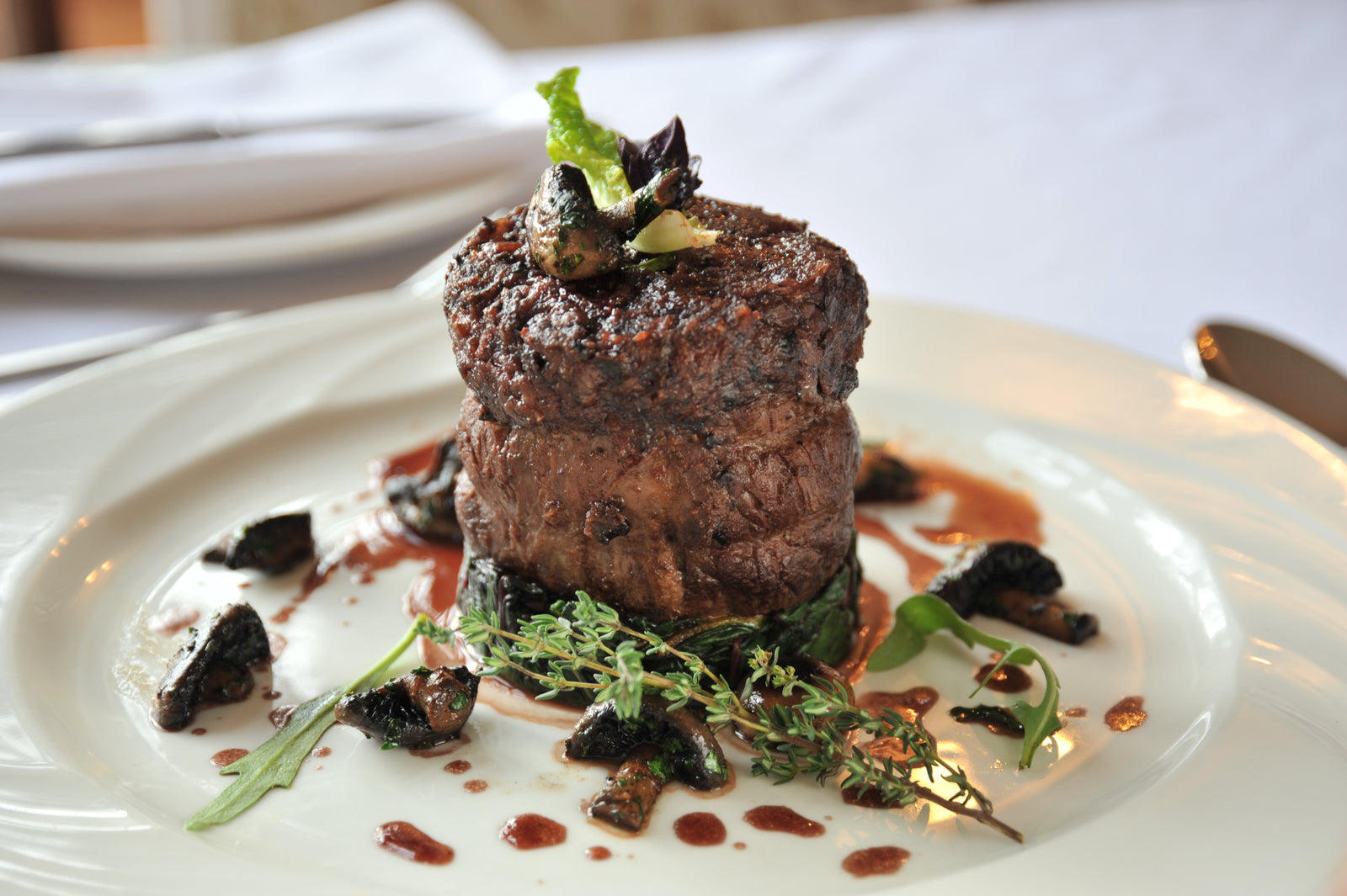 Beef fillet steak with mushrooms on a dark plate