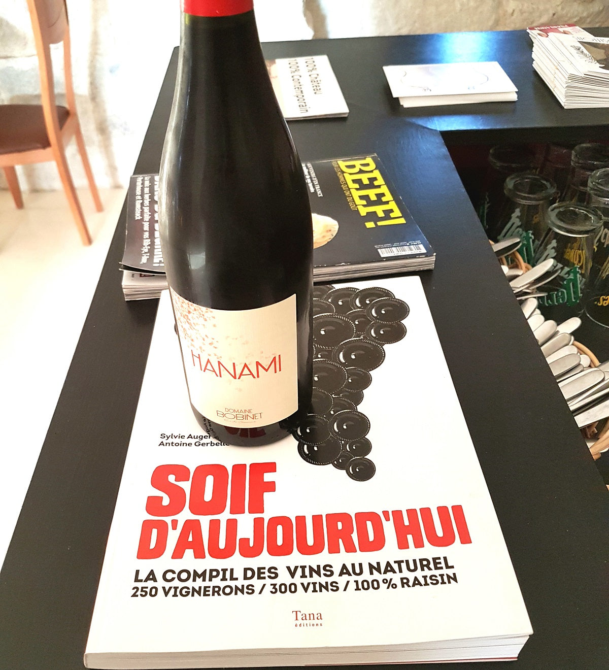 Bottles of natural wine on a wooden table in a Loire Valley restaurant