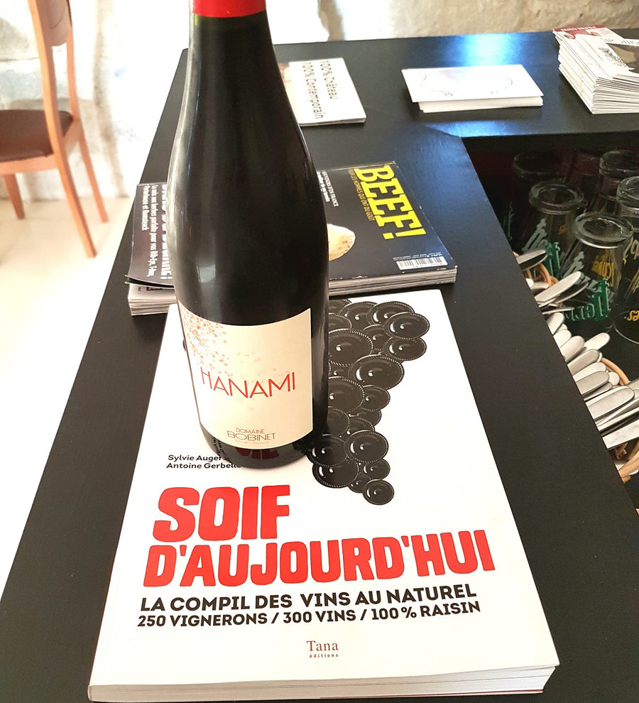 Bottles of natural wine on a wooden table in a Loire Valley restaurant